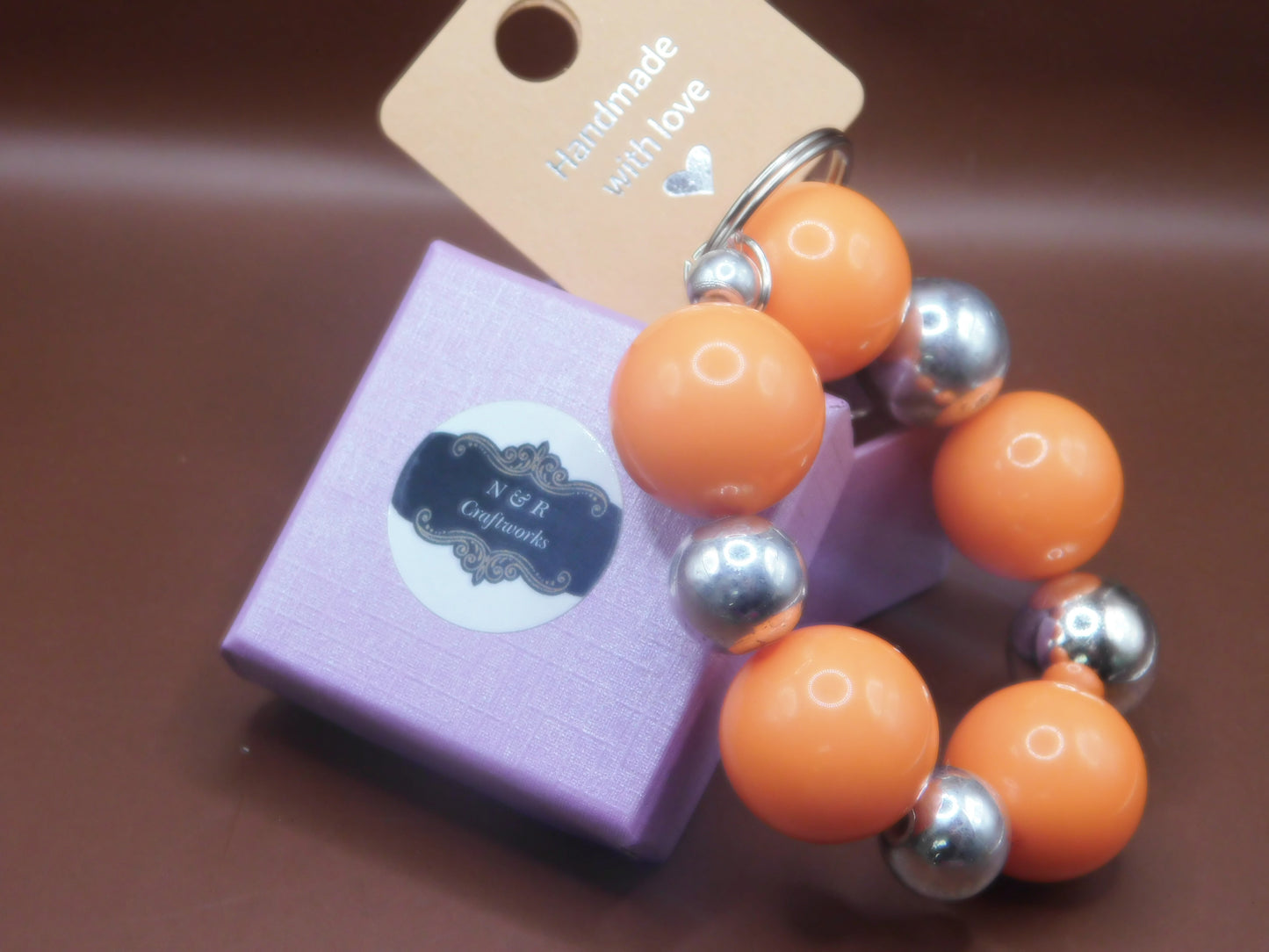 Keychain with Large orange beads and chrome beads